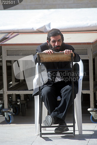 Image of Orthodox man prayers at Western wall of Jerusalem 