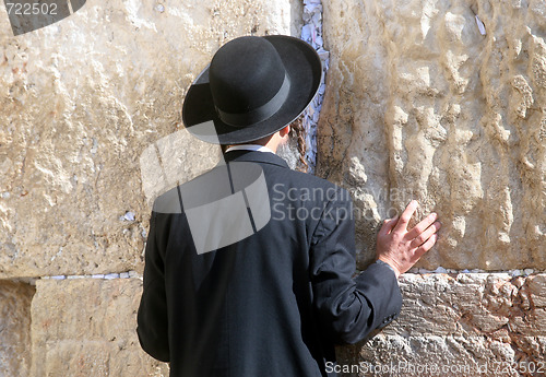Image of Orthodox man prayers at Western wall of Jerusalem 