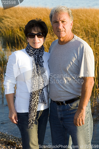 Image of happy middle age senior couple on beach