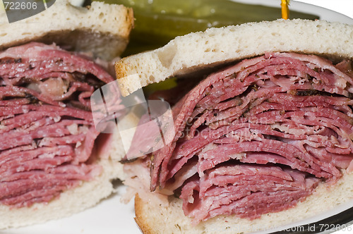 Image of corned beef pastrami combination sandwich rye bread pickles