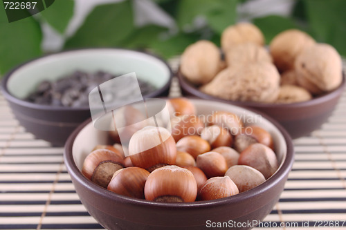 Image of Wood nuts in cup on bamboo napkin