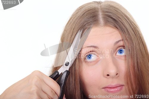 Image of The nice girl with scissors looking upwards