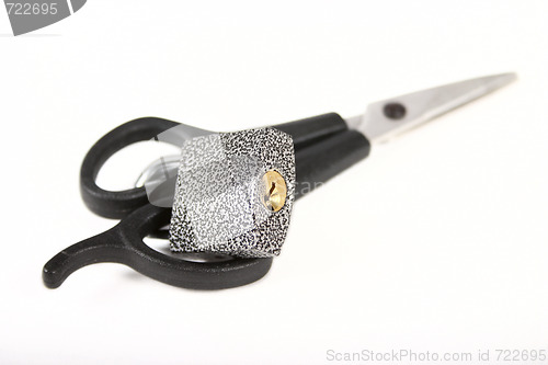 Image of Scissors locked on a padlock