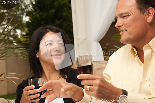 Image of Hispanic Woman and Caucasian Man Enjoying Wine