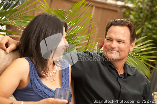 Image of Attractive Hispanic and Caucasian Couple Drinking Wine