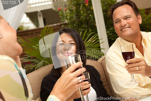 Image of Three Friends Enjoying Wine on the Patio