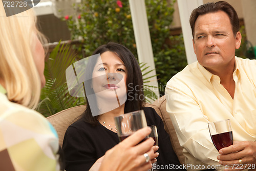 Image of Three Friends Enjoying Wine on the Patio