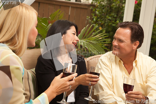 Image of Three Friends Enjoying Wine on the Patio