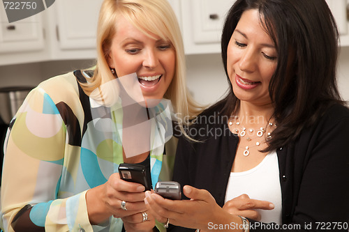 Image of Two Girlfriends Sharing with Their Cell Phones