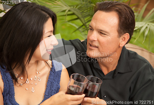 Image of Attractive Hispanic and Caucasian Couple Drinking Wine