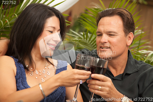 Image of Attractive Hispanic and Caucasian Couple Drinking Wine