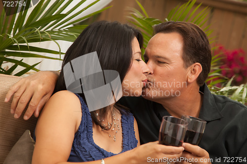 Image of Attractive Hispanic and Caucasian Couple Drinking Wine