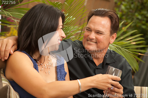 Image of Attractive Hispanic and Caucasian Couple Drinking Wine