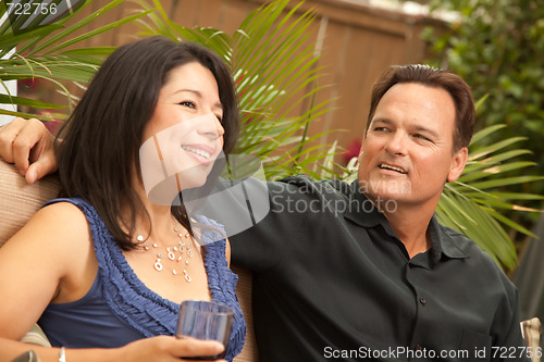 Image of Attractive Hispanic and Caucasian Couple Drinking Wine