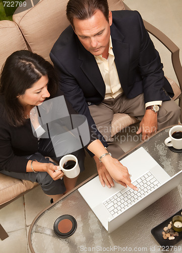 Image of Man and Woman Using Laptop with Coffee