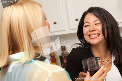 Image of Two Girlfriends Enjoy Wine in the Kitchen