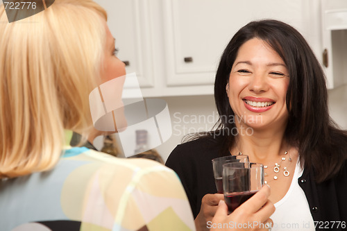 Image of Two Girlfriends Enjoy Wine in the Kitchen