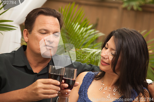 Image of Attractive Hispanic and Caucasian Couple Drinking Wine