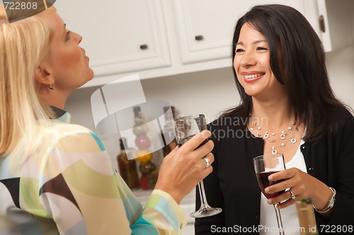 Image of Two Girlfriends Enjoy Wine in the Kitchen