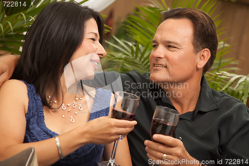 Image of Attractive Hispanic and Caucasian Couple Drinking Wine