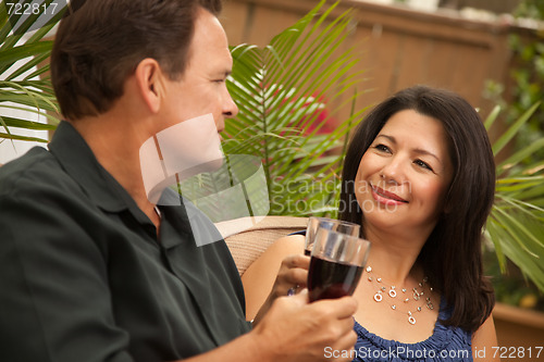Image of Attractive Hispanic and Caucasian Couple Drinking Wine