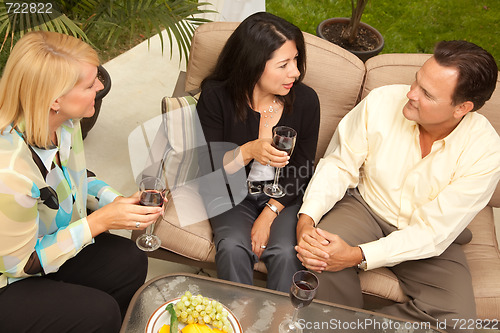 Image of Three Friends Enjoying Wine on the Patio