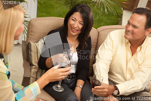 Image of Three Friends Enjoying Wine on the Patio