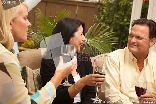 Image of Three Friends Enjoying Wine on the Patio