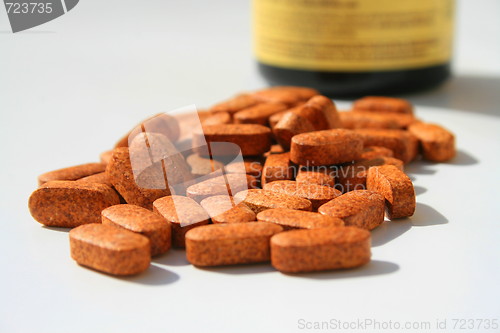 Image of Pills next to a Container