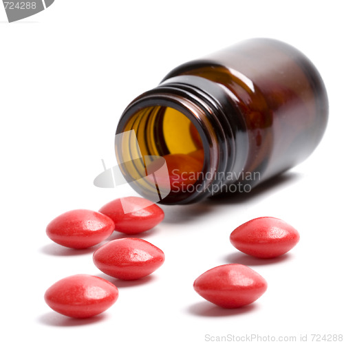 Image of bottle with red pills