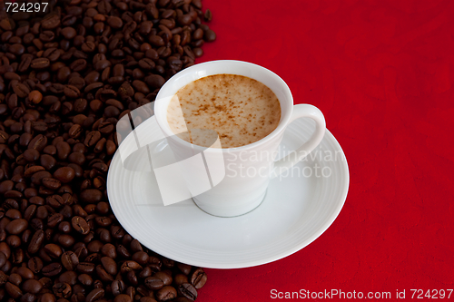 Image of cup with coffee and grain expressed on red background