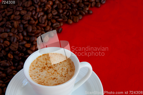 Image of cup with coffee and grain expressed on red background