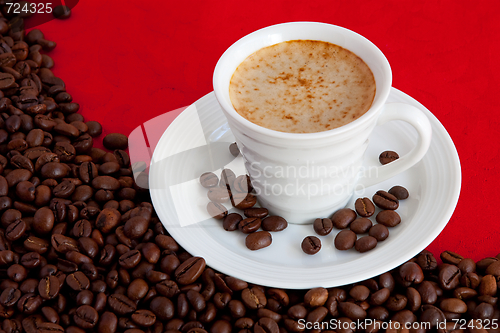 Image of cup with coffee and grain expressed on red background