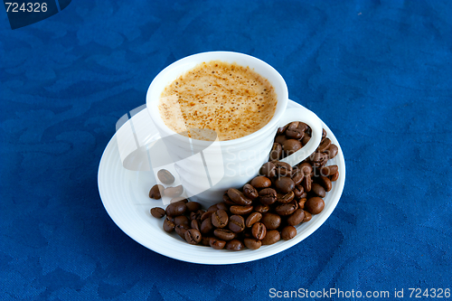 Image of cup with coffee and grain expressed on blue background