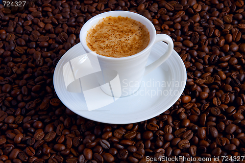 Image of Cup with coffee, costing on coffee grain