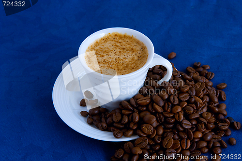 Image of cup with coffee and grain expressed on blue background