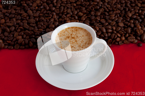 Image of cup with coffee and grain expressed on red background