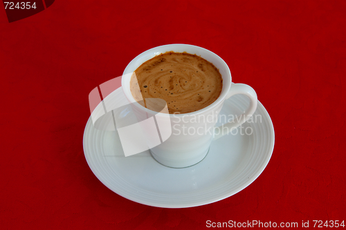 Image of cup with coffee and grain expressed on red background