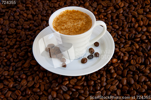 Image of Cup with coffee, costing on coffee grain