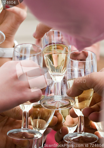 Image of Glasses of champagne clinking.