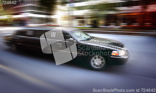 Image of Limosine driving down street 