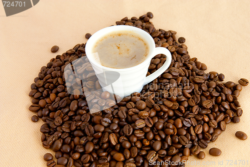 Image of Cup with coffee, costing on coffee grain