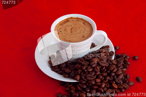Image of cup with coffee and grain expressed on red background