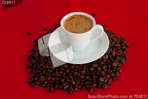 Image of Cup with coffee, costing on coffee grain