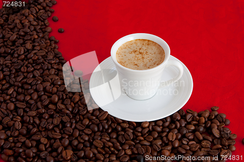 Image of cup with coffee and grain expressed on red background