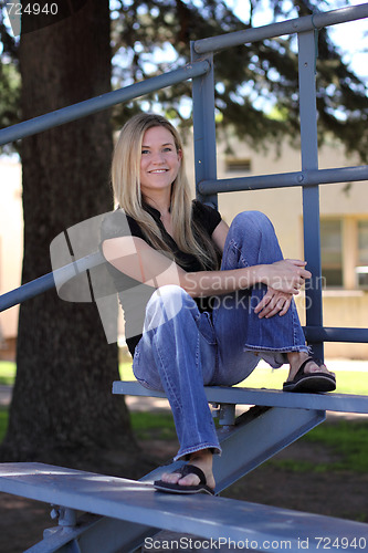 Image of Woman Relaxing on Bleacher