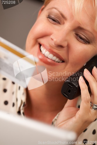 Image of Beautiful Woman on Phone Holding Credit Card