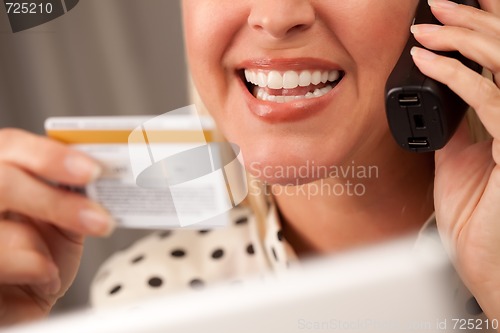 Image of Beautiful Woman on Phone Holding Credit Card