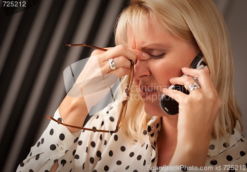 Image of Blonde Woman on Cell Phone with Stressed Look