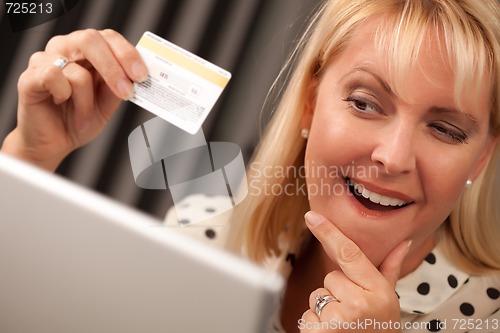 Image of Beautiful Woman Using Laptop Holding Her Credit Card